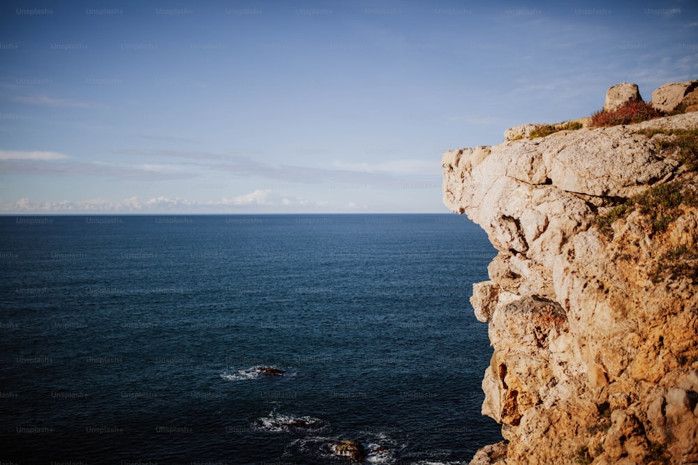 a rocky cliff overlooks a body of water