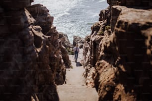 a couple of people that are walking down some rocks
