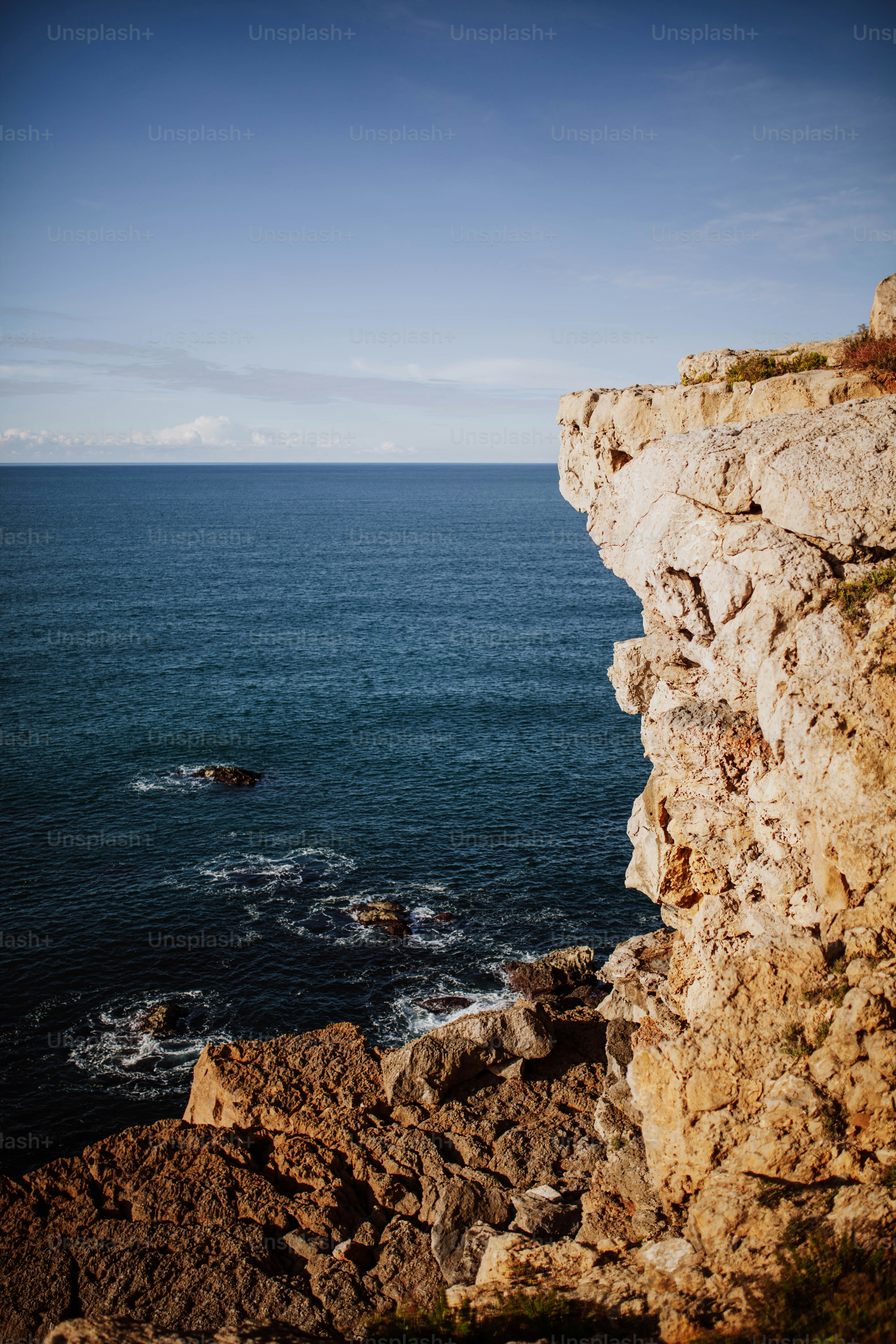 a person standing on a cliff overlooking the ocean