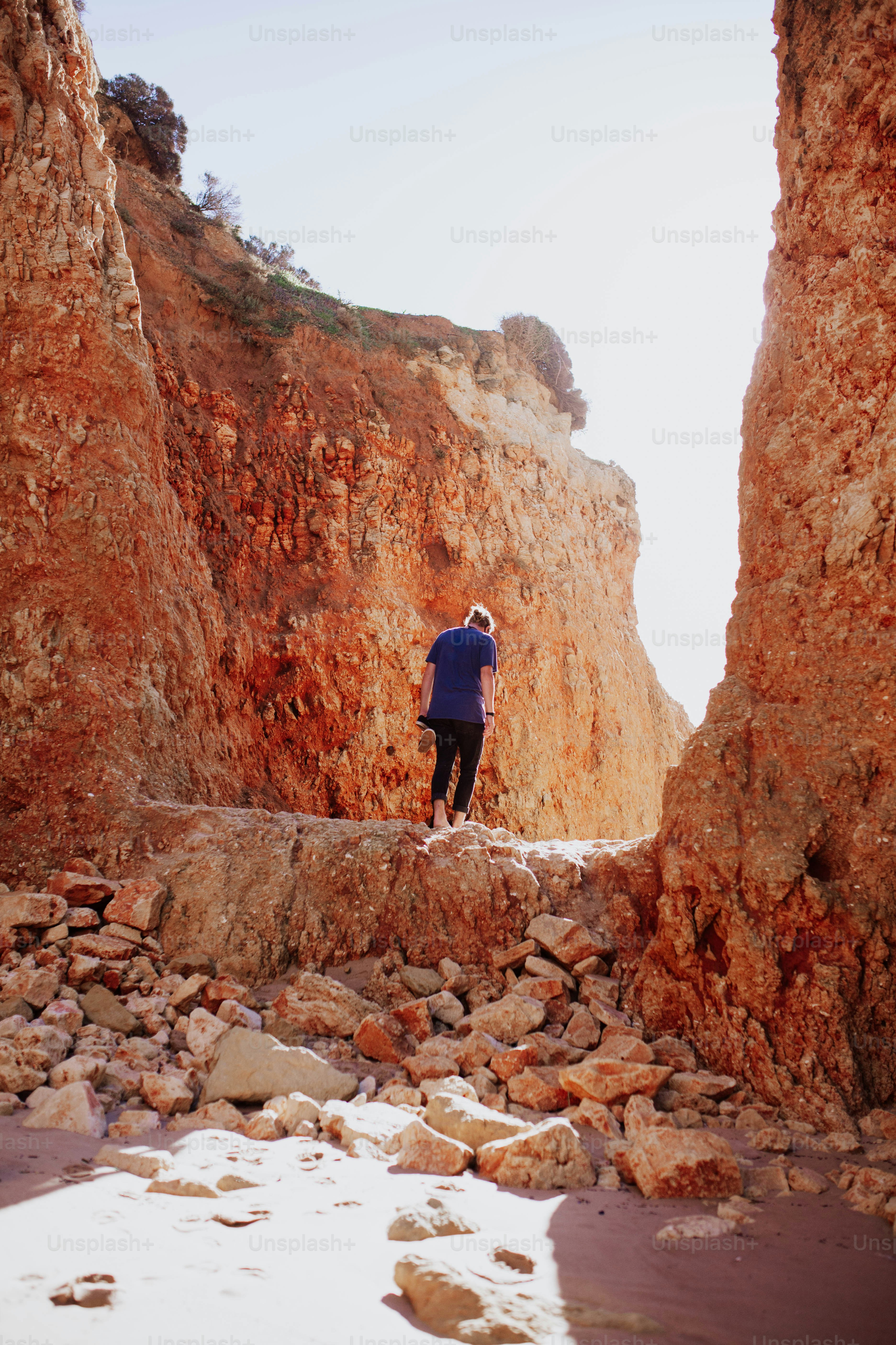a man standing on top of a pile of rocks