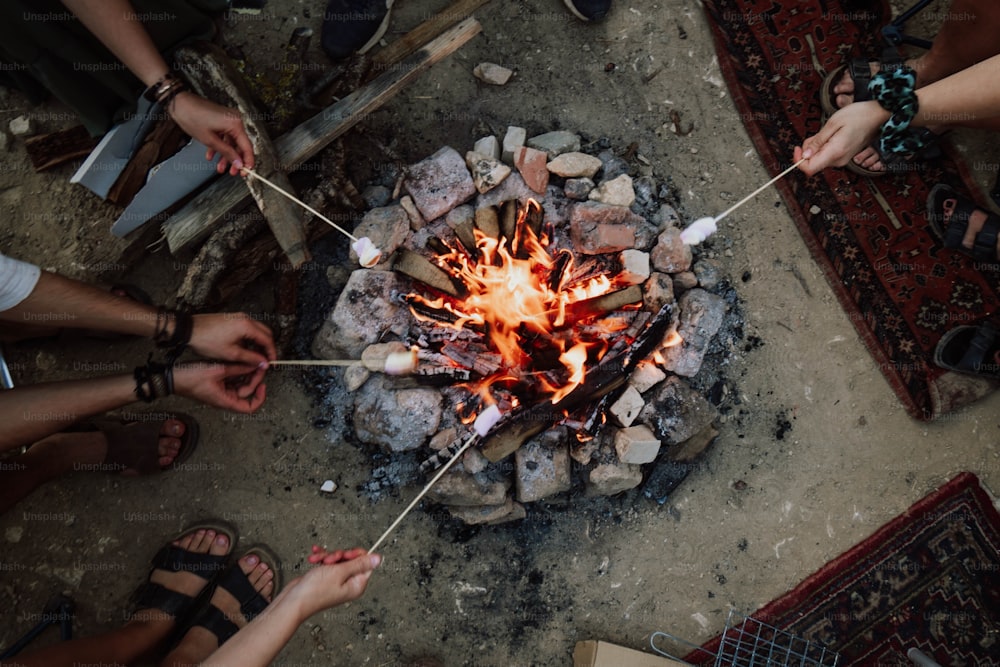 a group of people standing around a fire pit