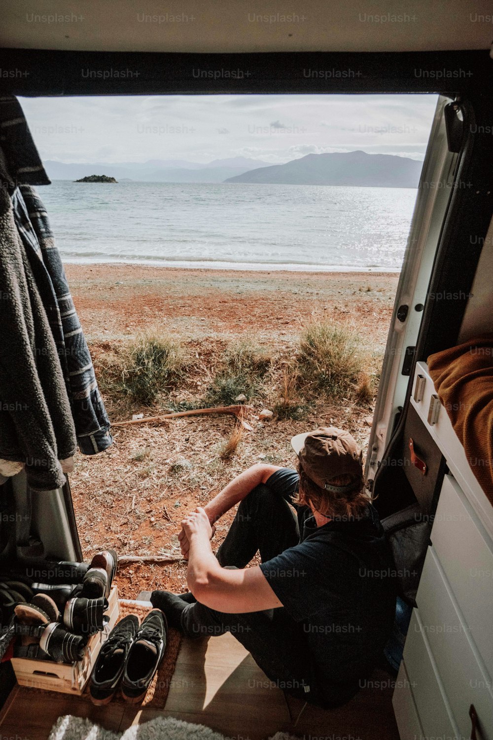 a person sitting in a van looking out the window