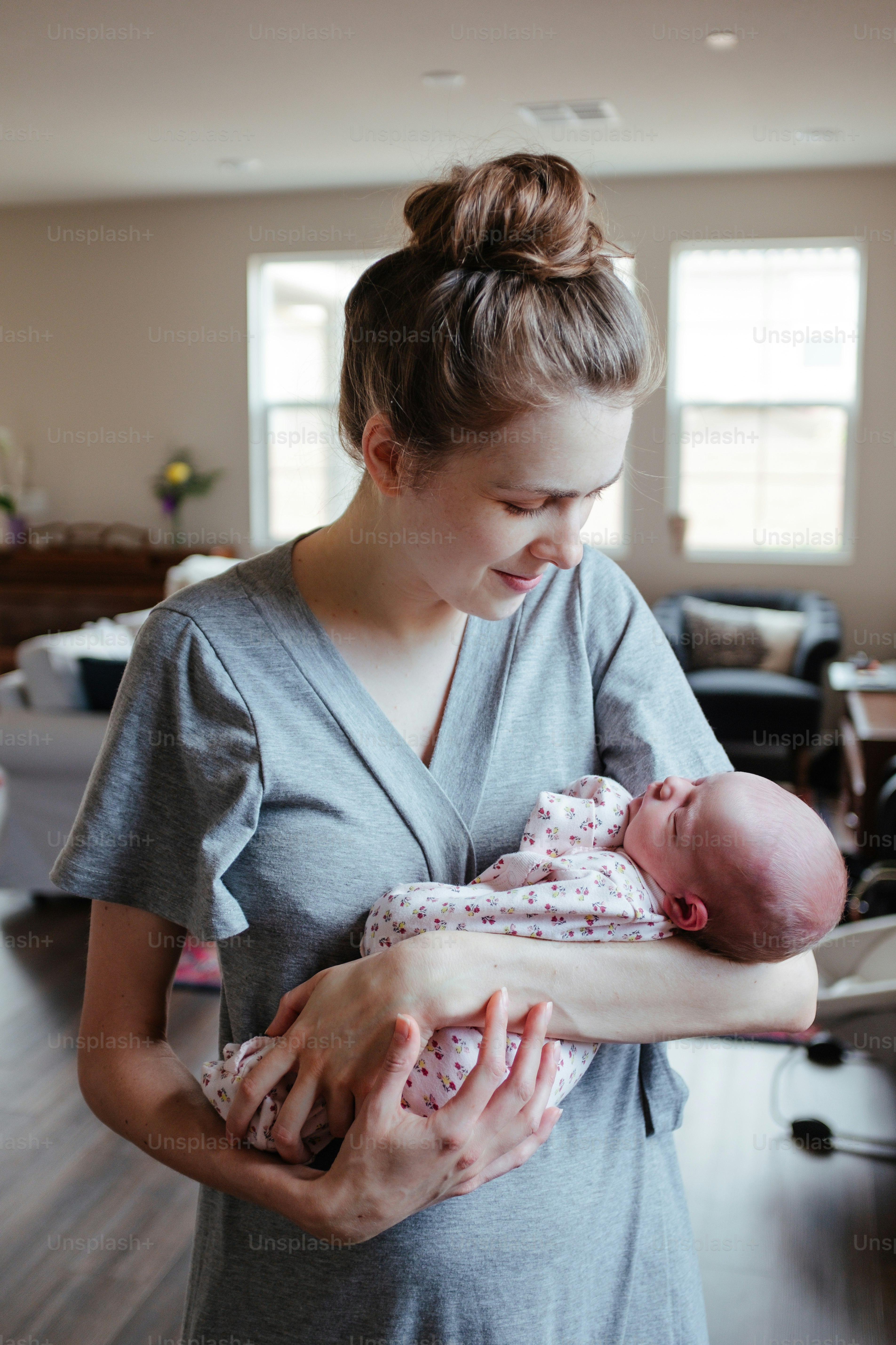 a woman holding a baby in her arms