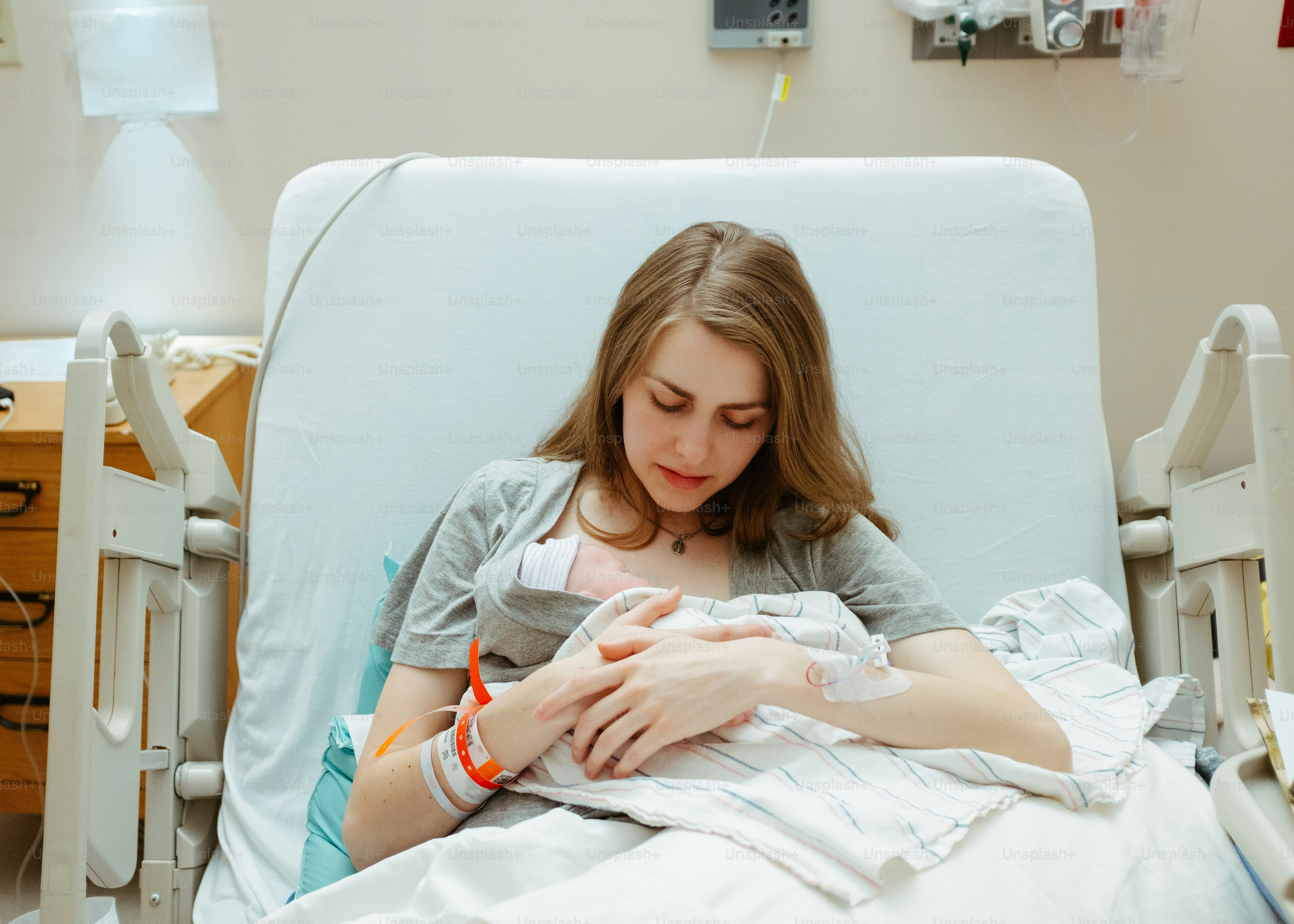 a woman in a hospital bed holding a baby