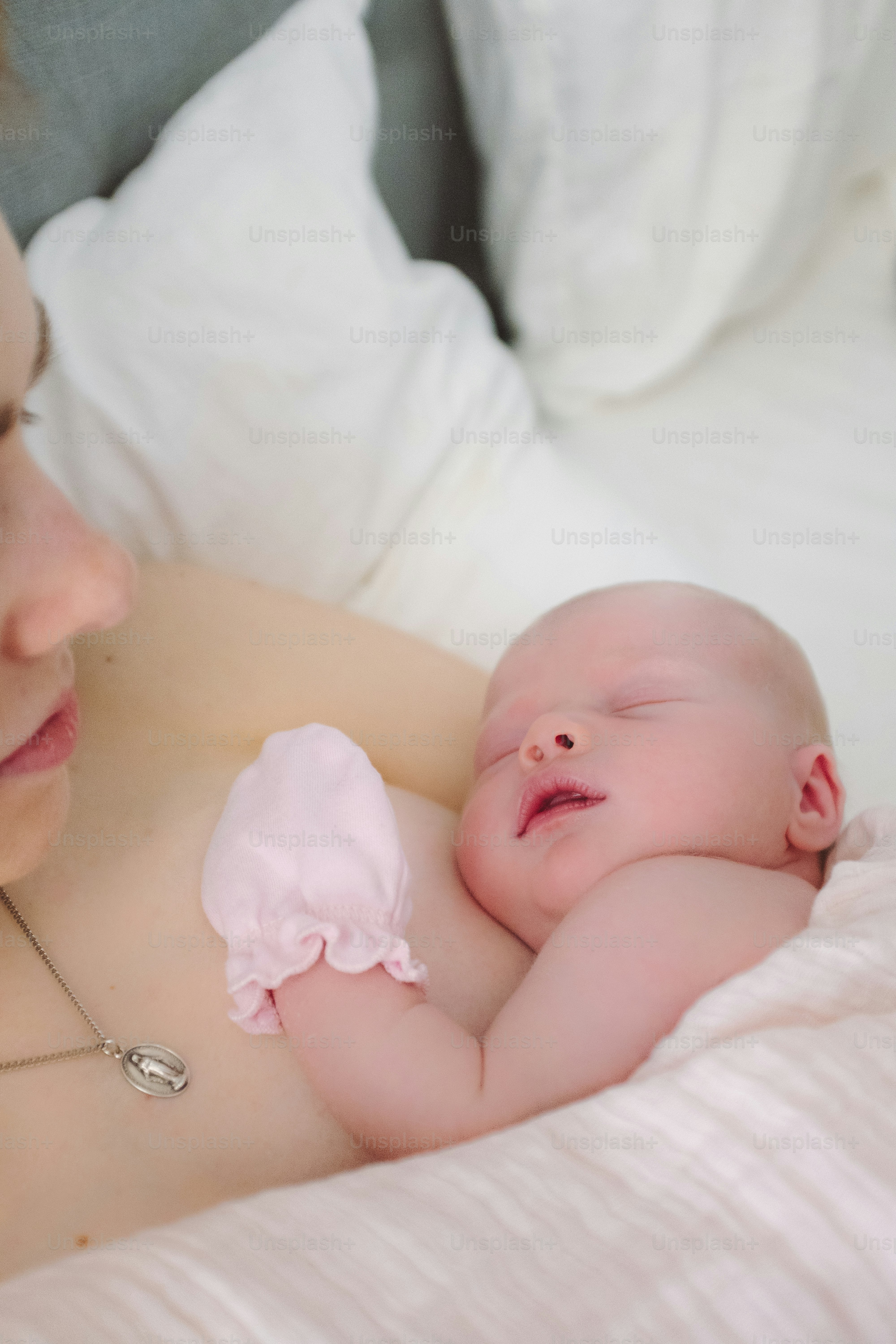 Mother gently holding sleeping newborn