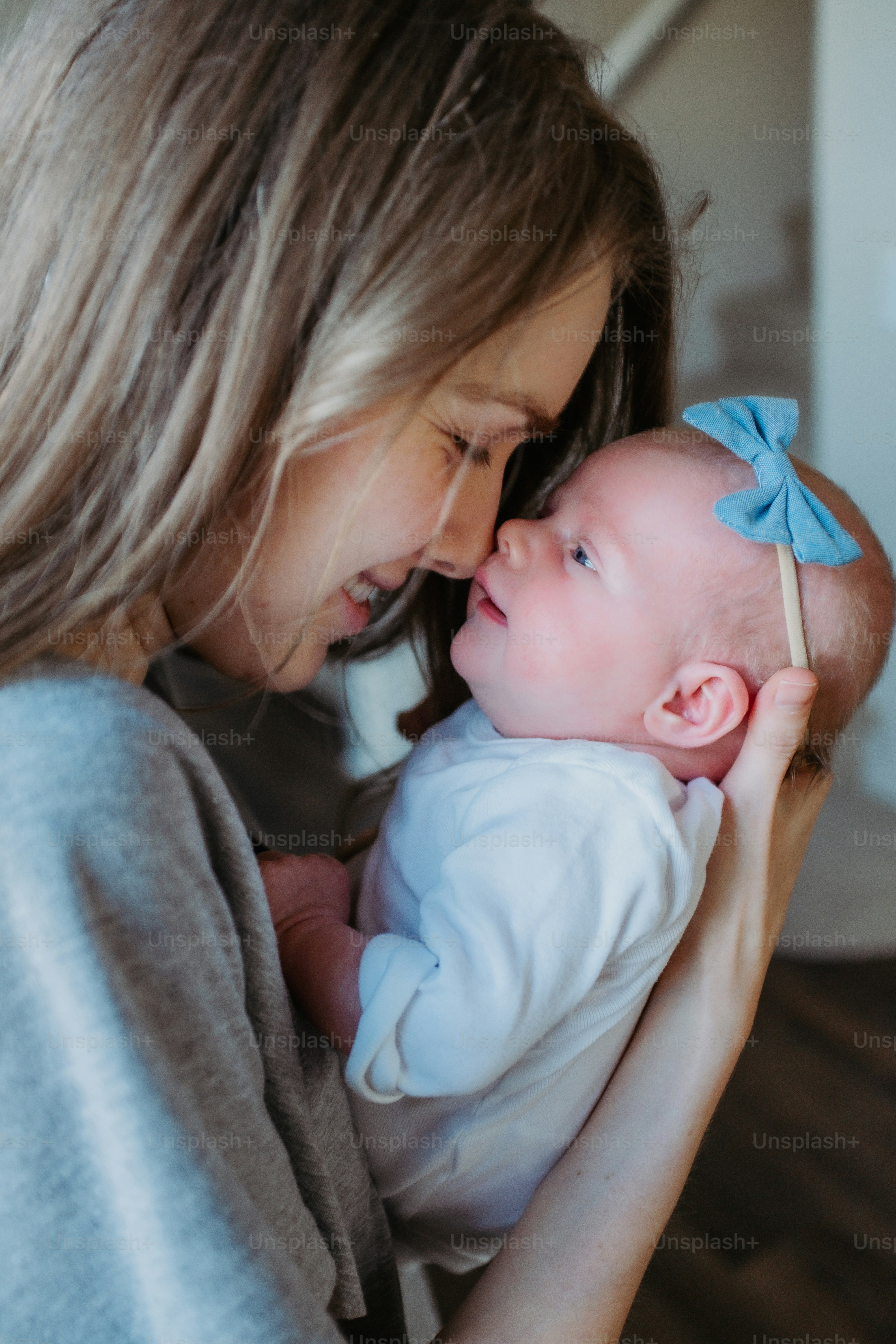 a woman holding a baby in her arms