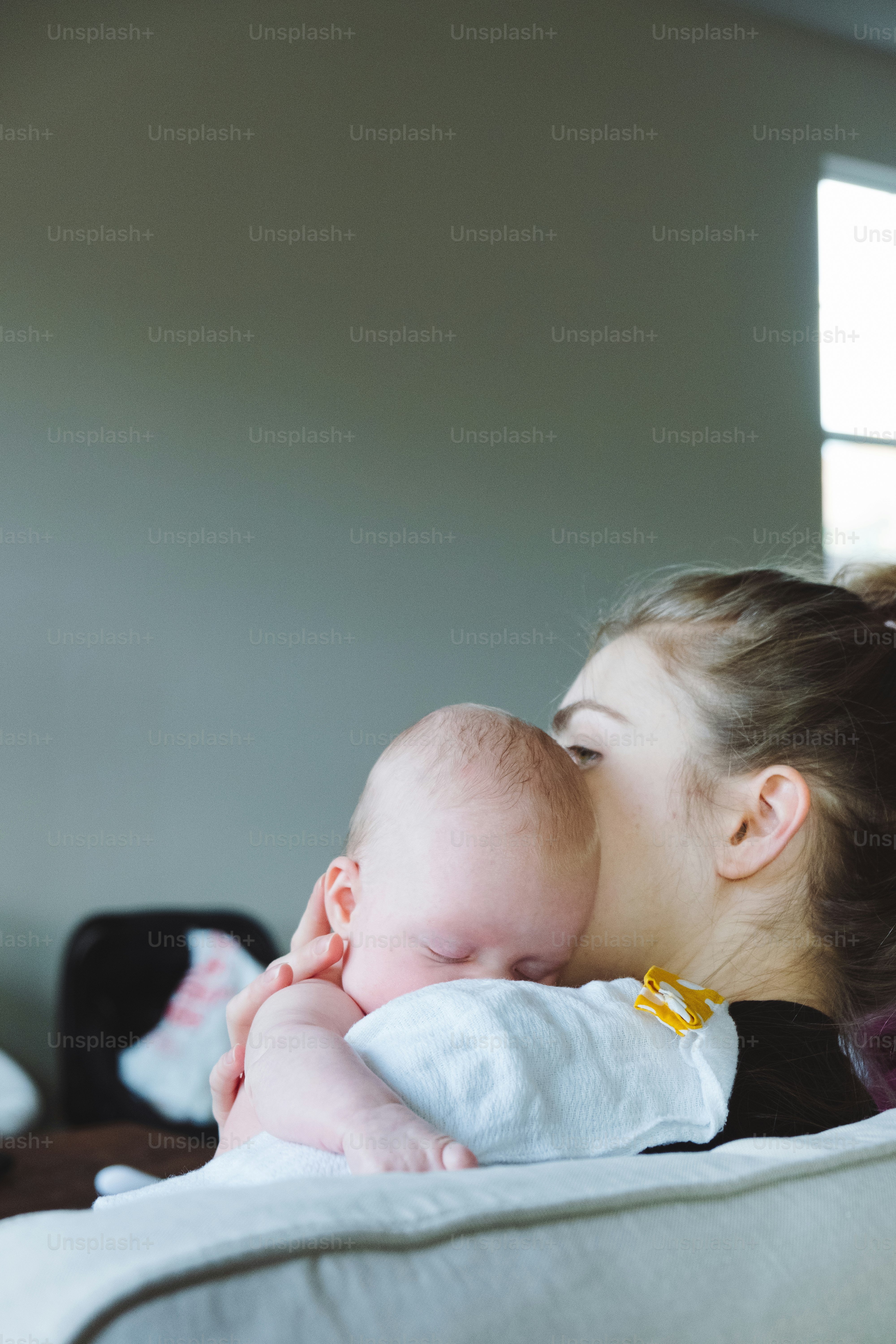 a woman holding a baby in her arms