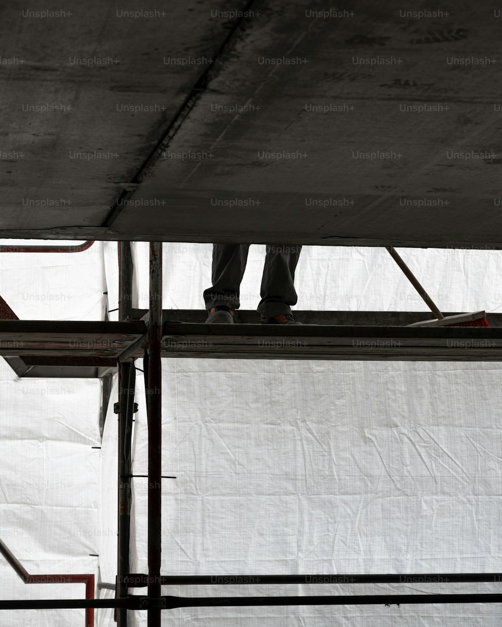 a person standing on a ledge with a skateboard