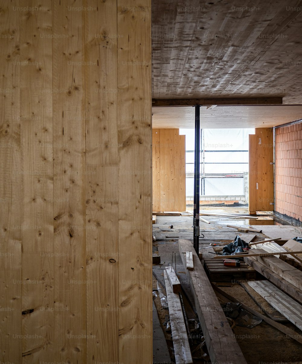 uma sala inacabada com paredes e piso de madeira