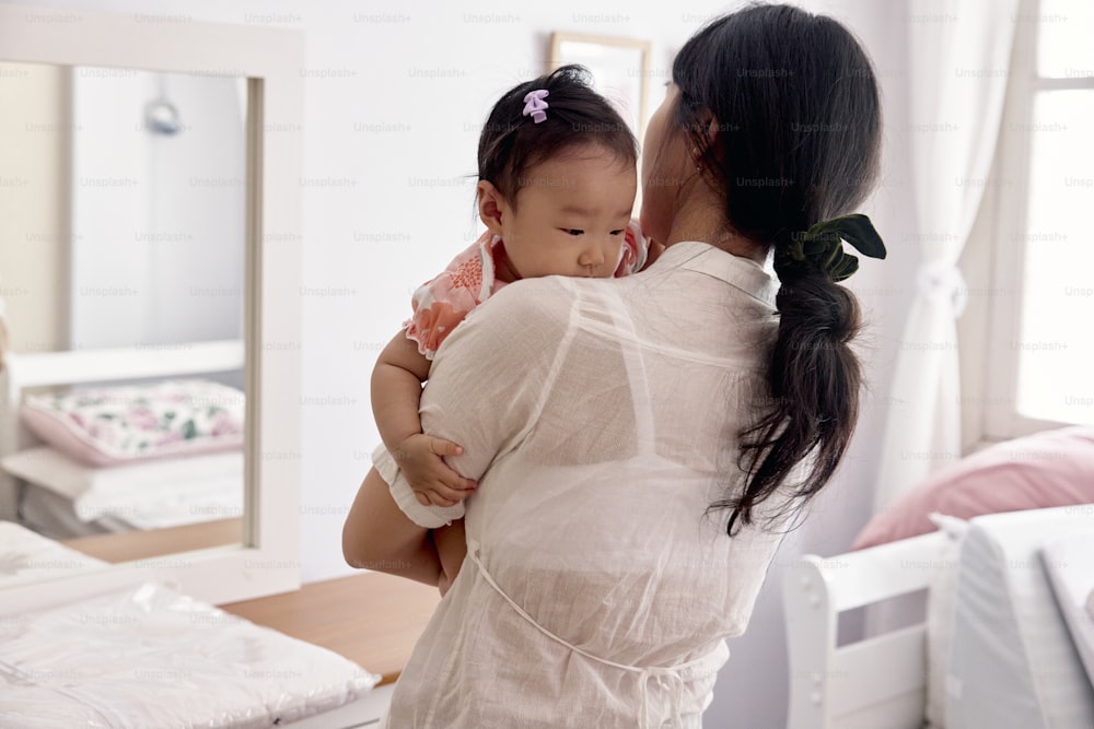 a woman holding a baby in her arms