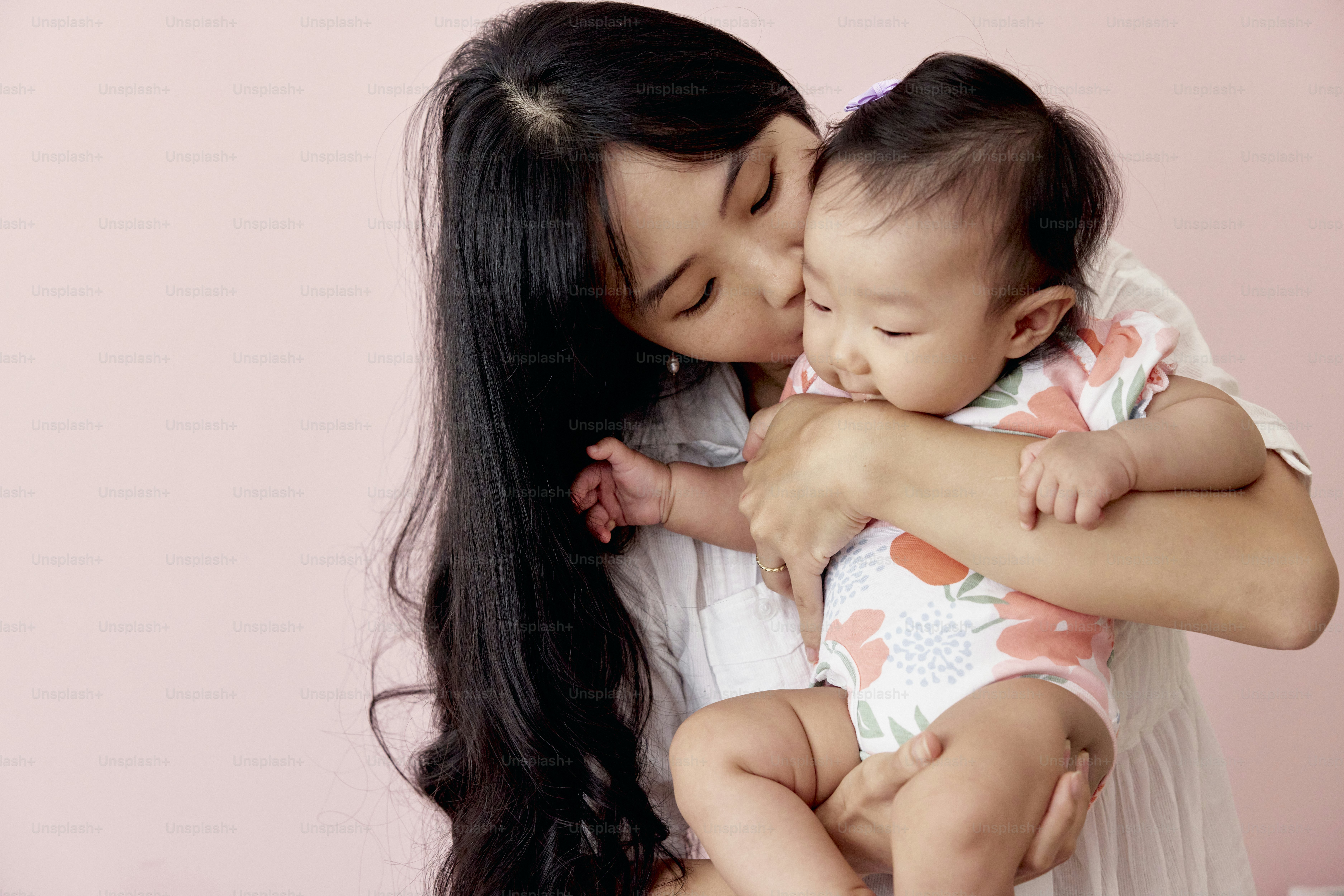 a woman holding a baby in her arms