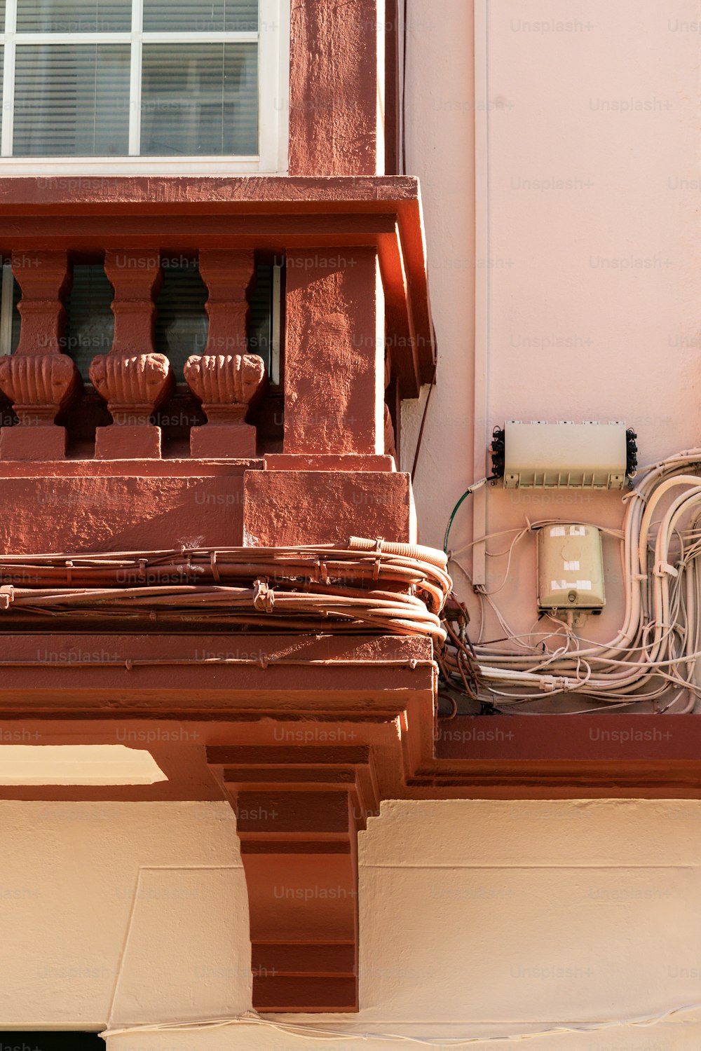 a close up of a building with a phone and wires