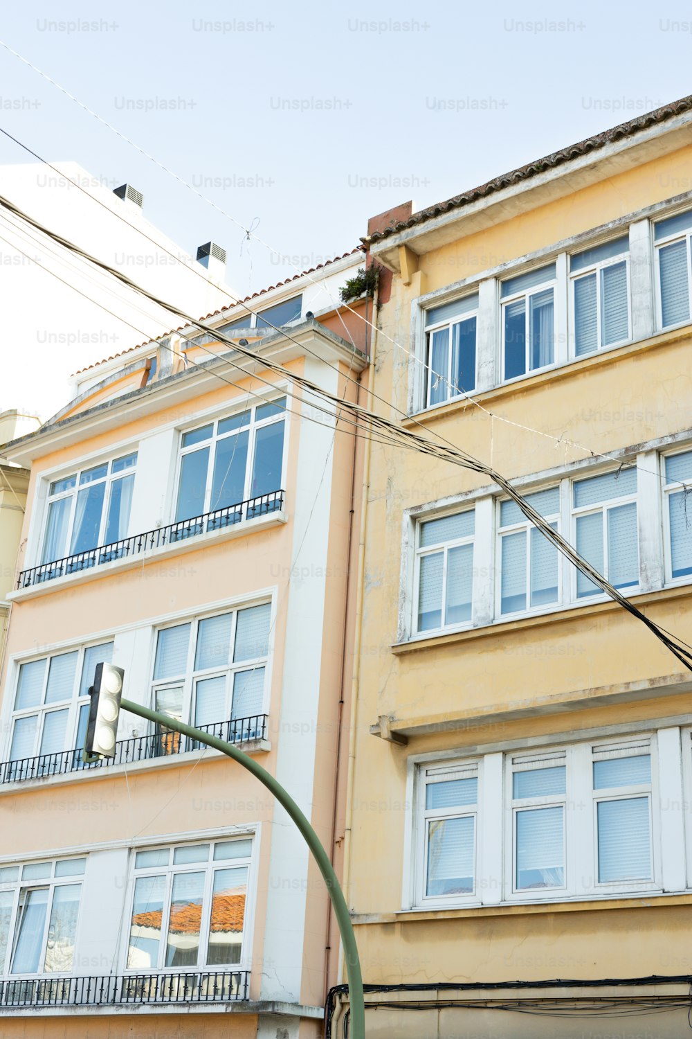 a tall yellow building sitting next to a traffic light