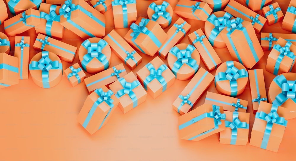 a pile of orange gift boxes with blue bows