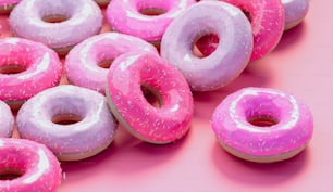 a group of donuts with pink frosting and sprinkles