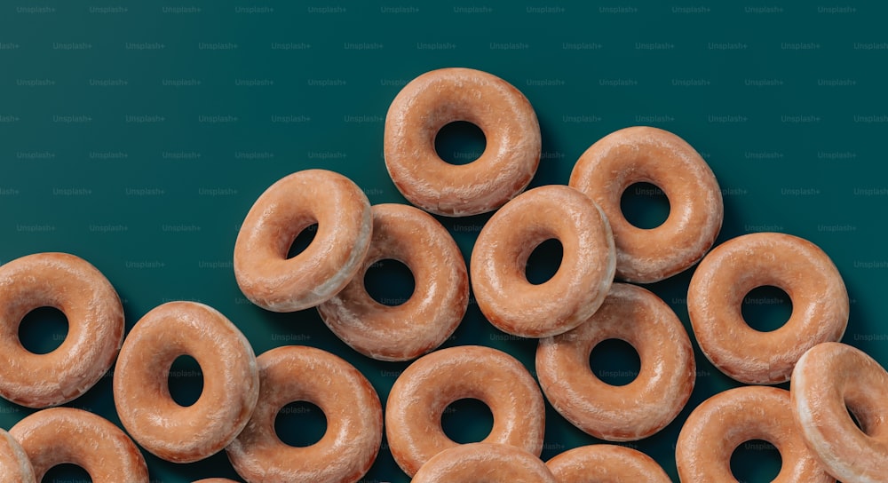 a pile of glazed donuts sitting on top of a table