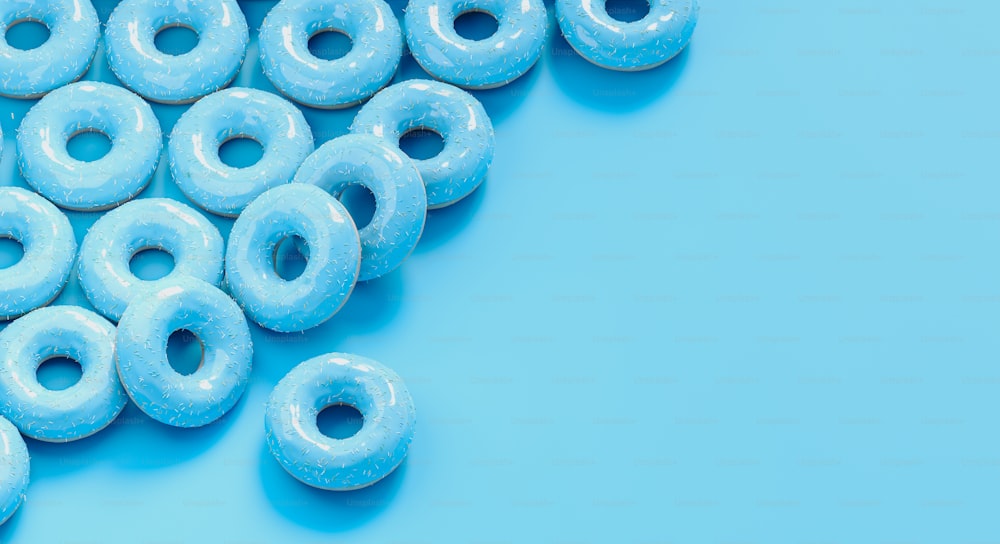 a group of blue glazed donuts on a blue background