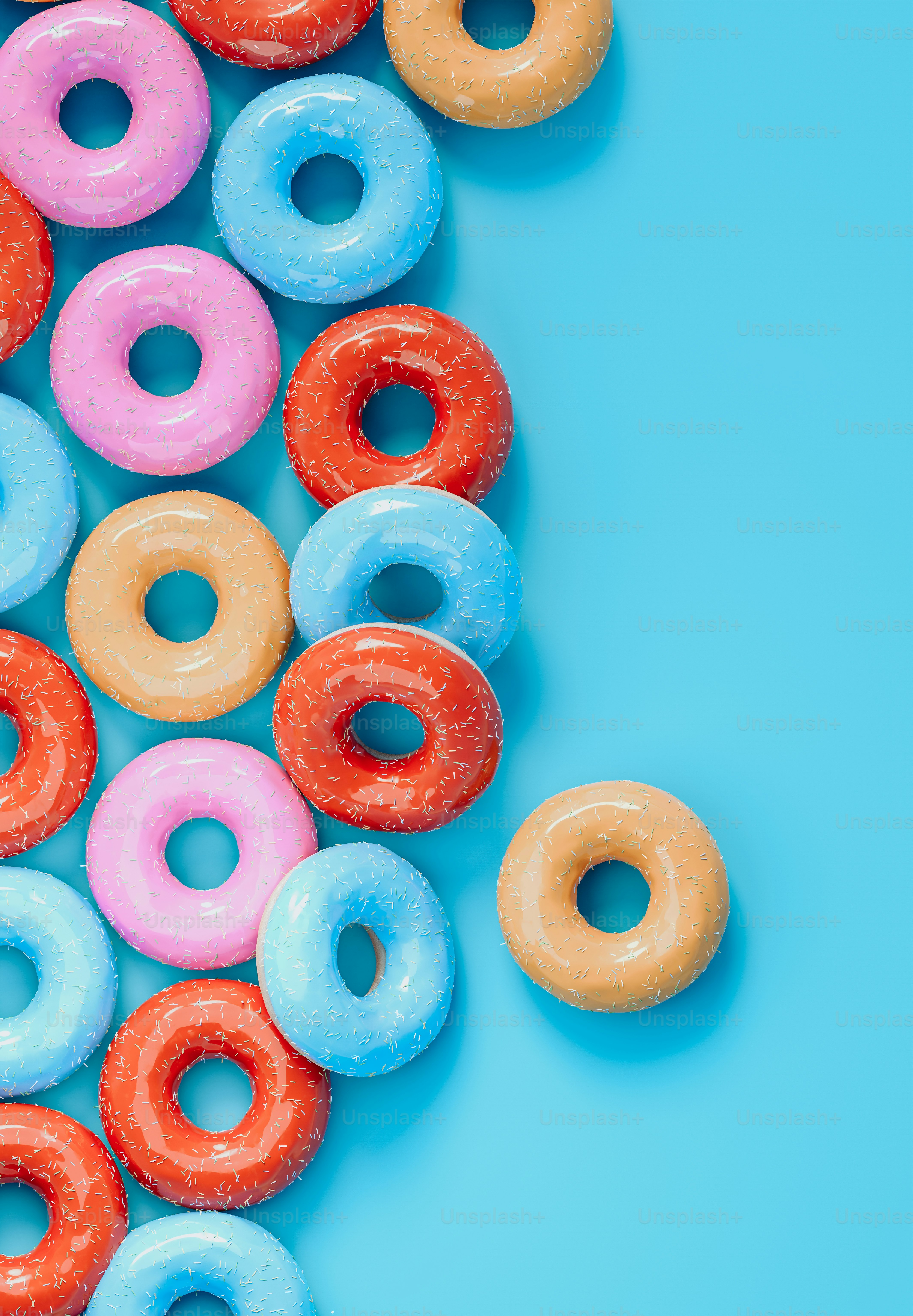 a bunch of doughnuts that are on a blue surface