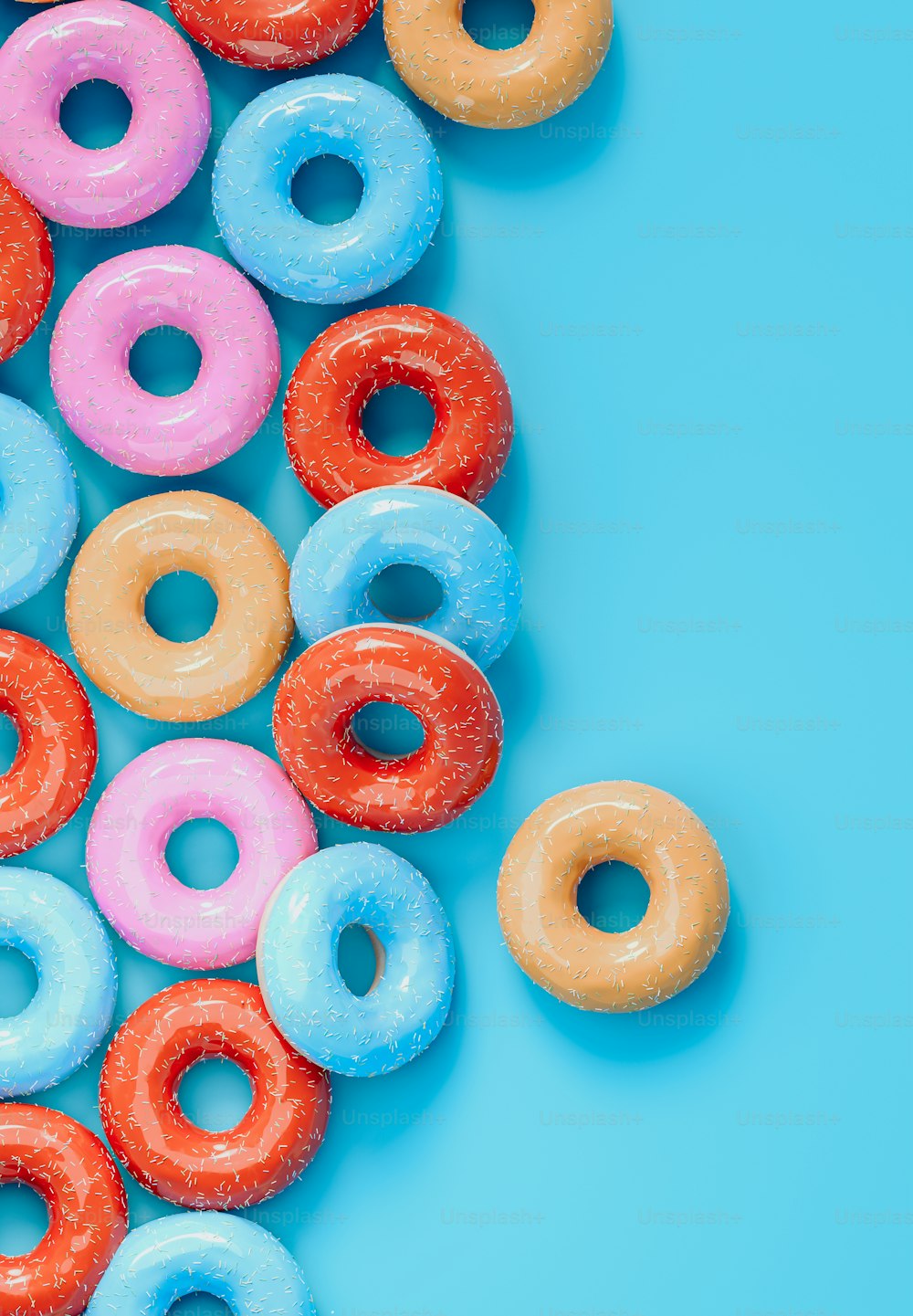 a bunch of doughnuts that are on a blue surface