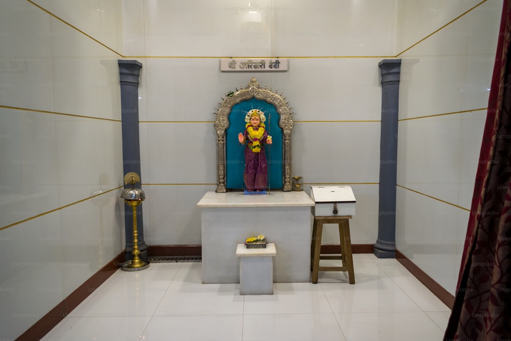 a small shrine with a statue of a person on it