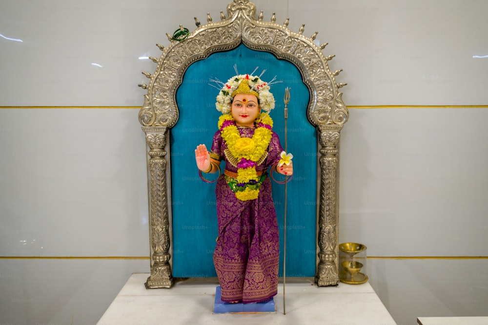 a statue of a woman in a purple outfit