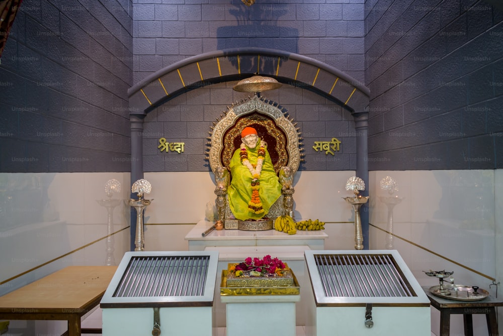 a small shrine with a statue of a hindu god