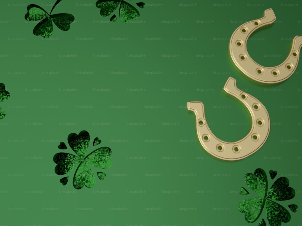a pair of horseshoes and clover leaves on a green background