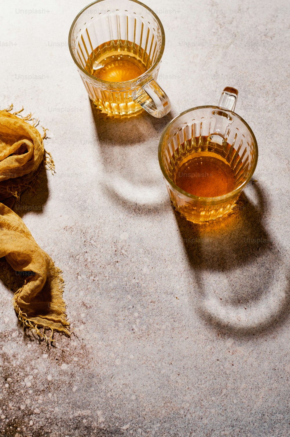 a cup of tea and a scarf on a table