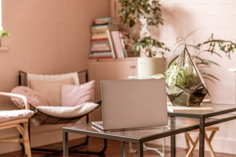 a laptop computer sitting on top of a glass table