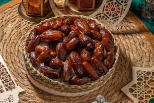 a bowl filled with dates sitting on top of a table