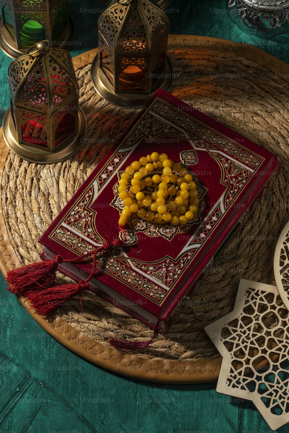 a red book on a tray with yellow beads