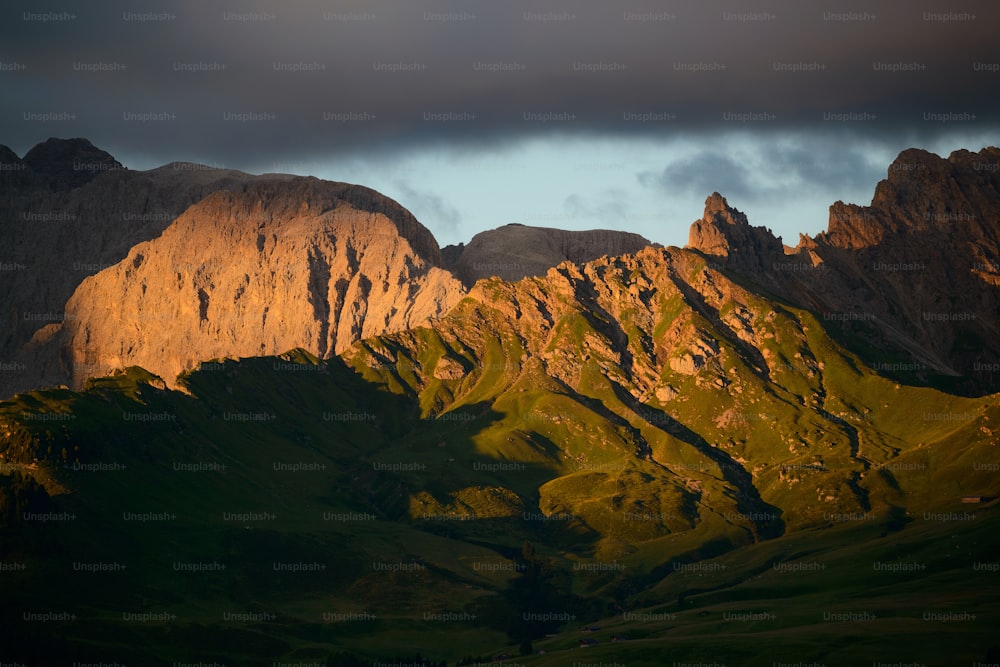 the sun is shining on a mountain range