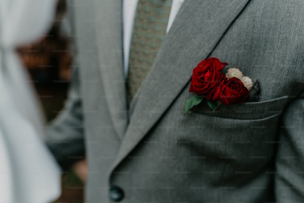 a man in a suit with a boutonniere on his lapel