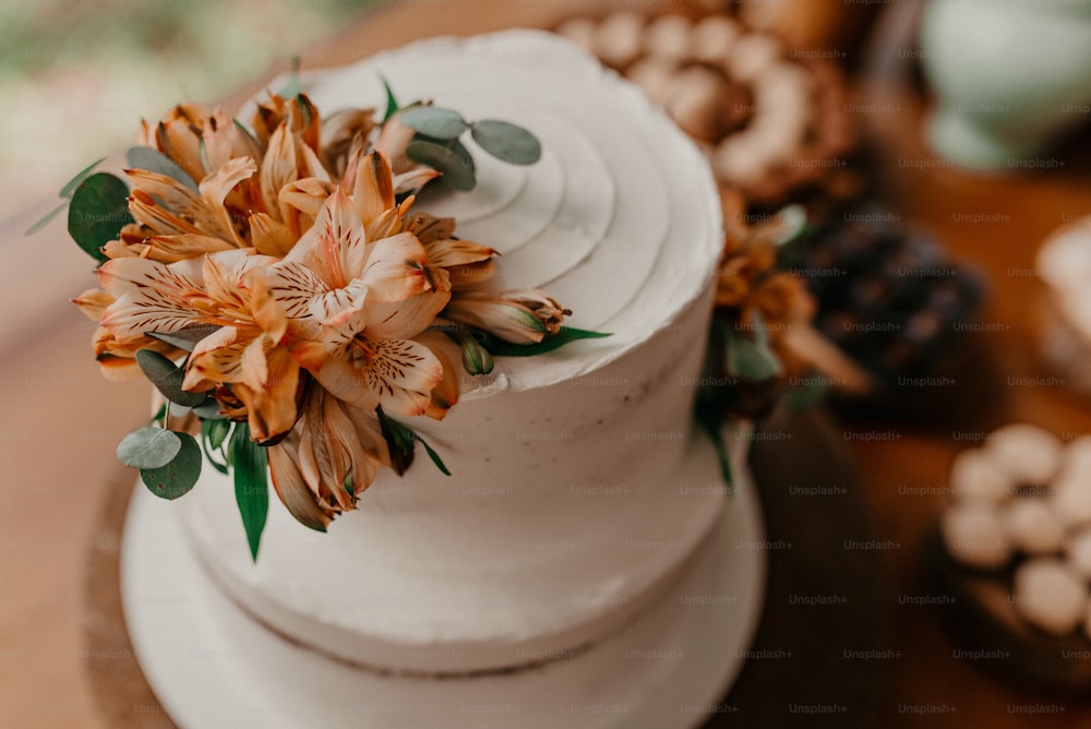 위에 꽃이 달린 흰색 케이크의 클로즈업