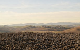 a view of a field with hills in the distance