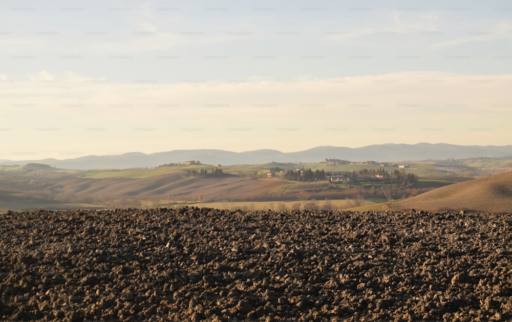 a view of a field with hills in the distance