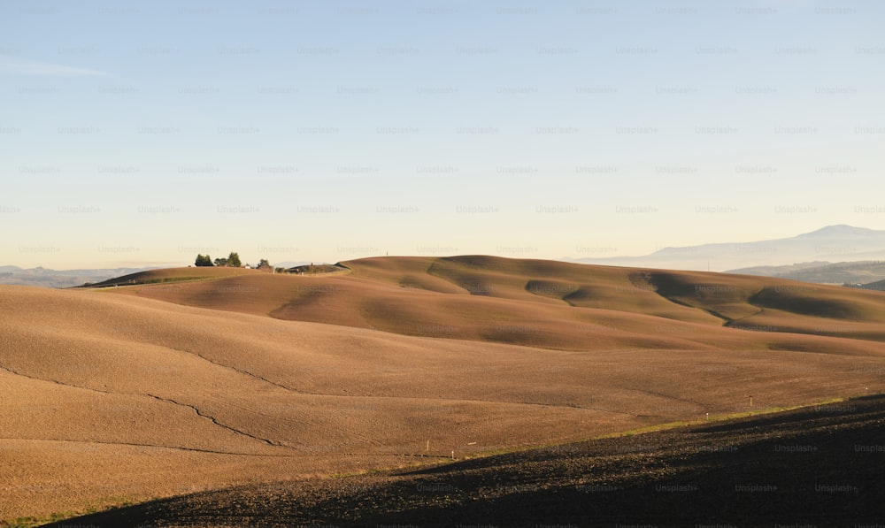 a view of the rolling hills and trees in the distance