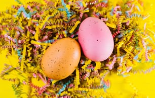 two eggs are sitting in a pile of confetti