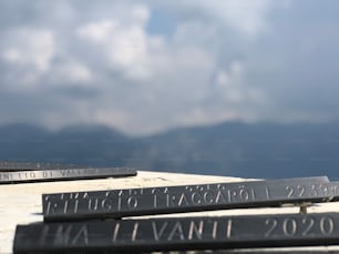 a close up of a street sign with mountains in the background