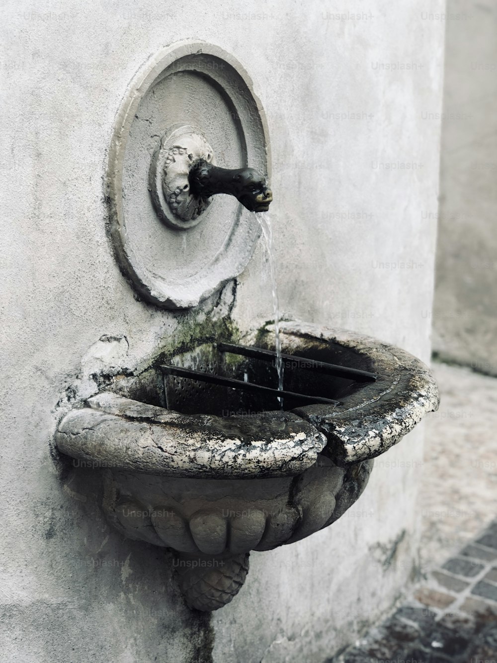 a water fountain with a faucet running out of it