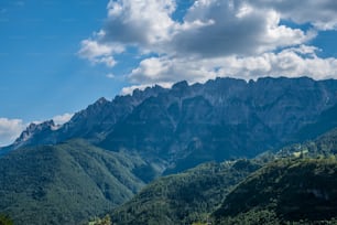 a view of a mountain range with clouds in the sky