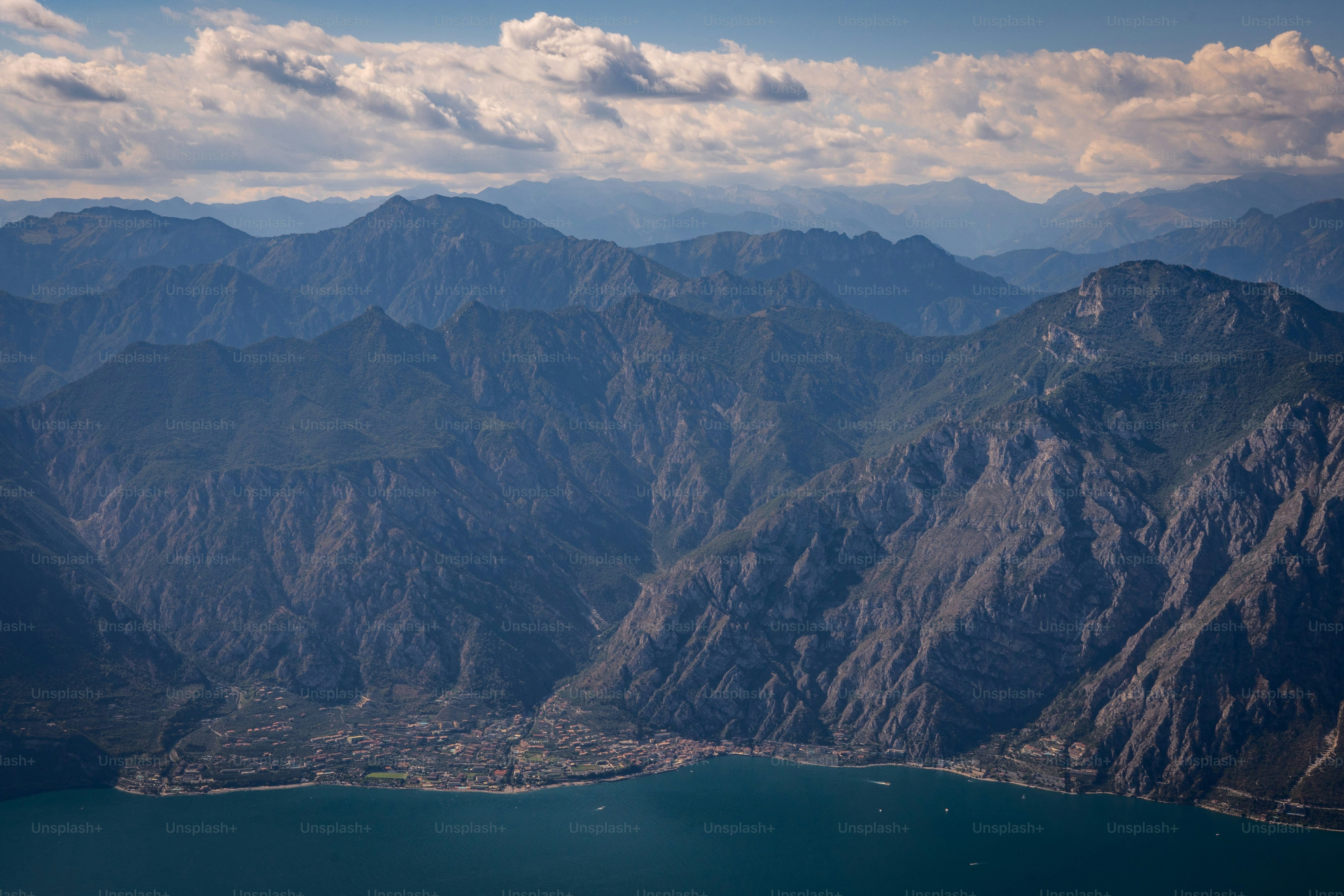 a view of a mountain range with a body of water in the foreground