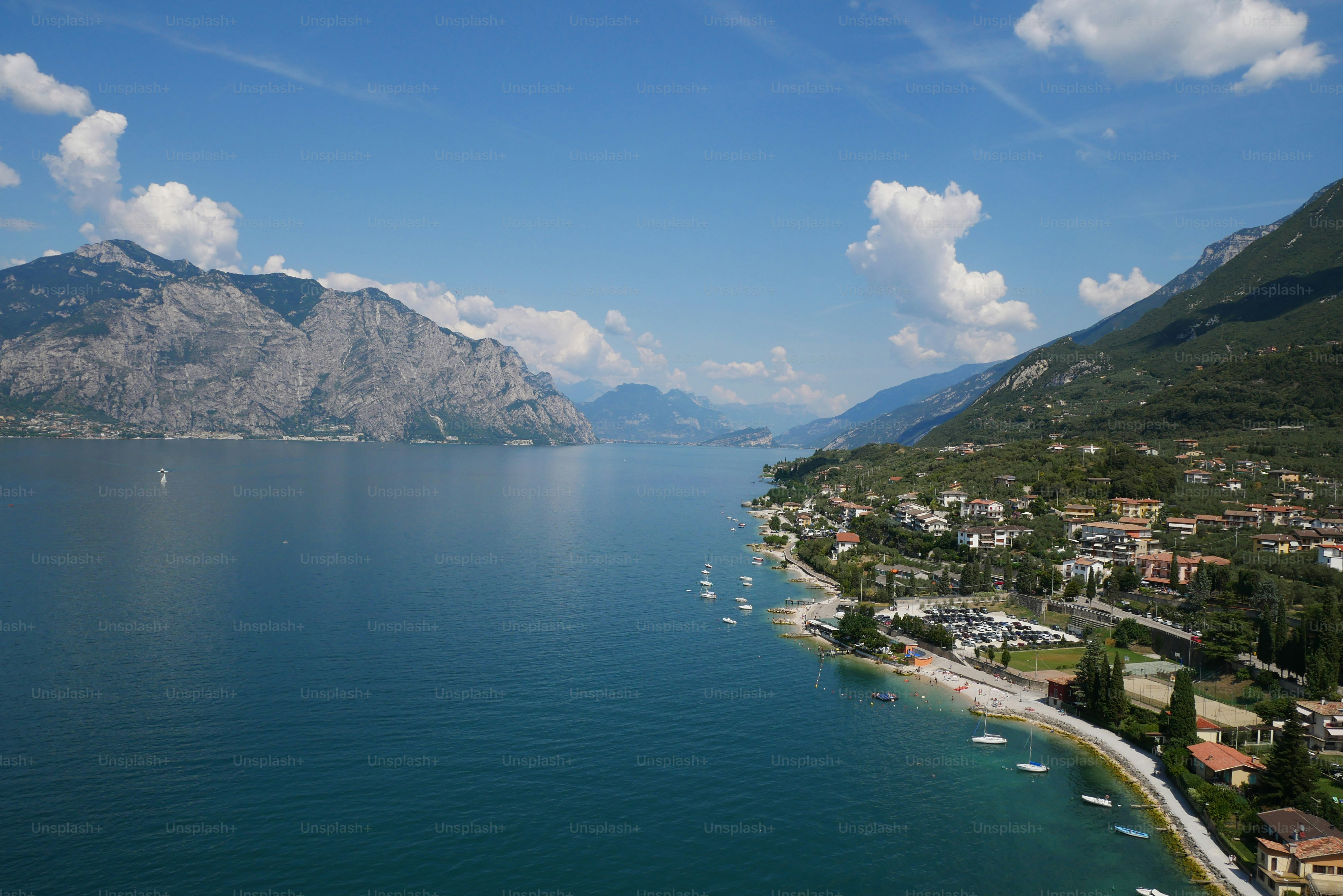 a body of water surrounded by mountains and houses