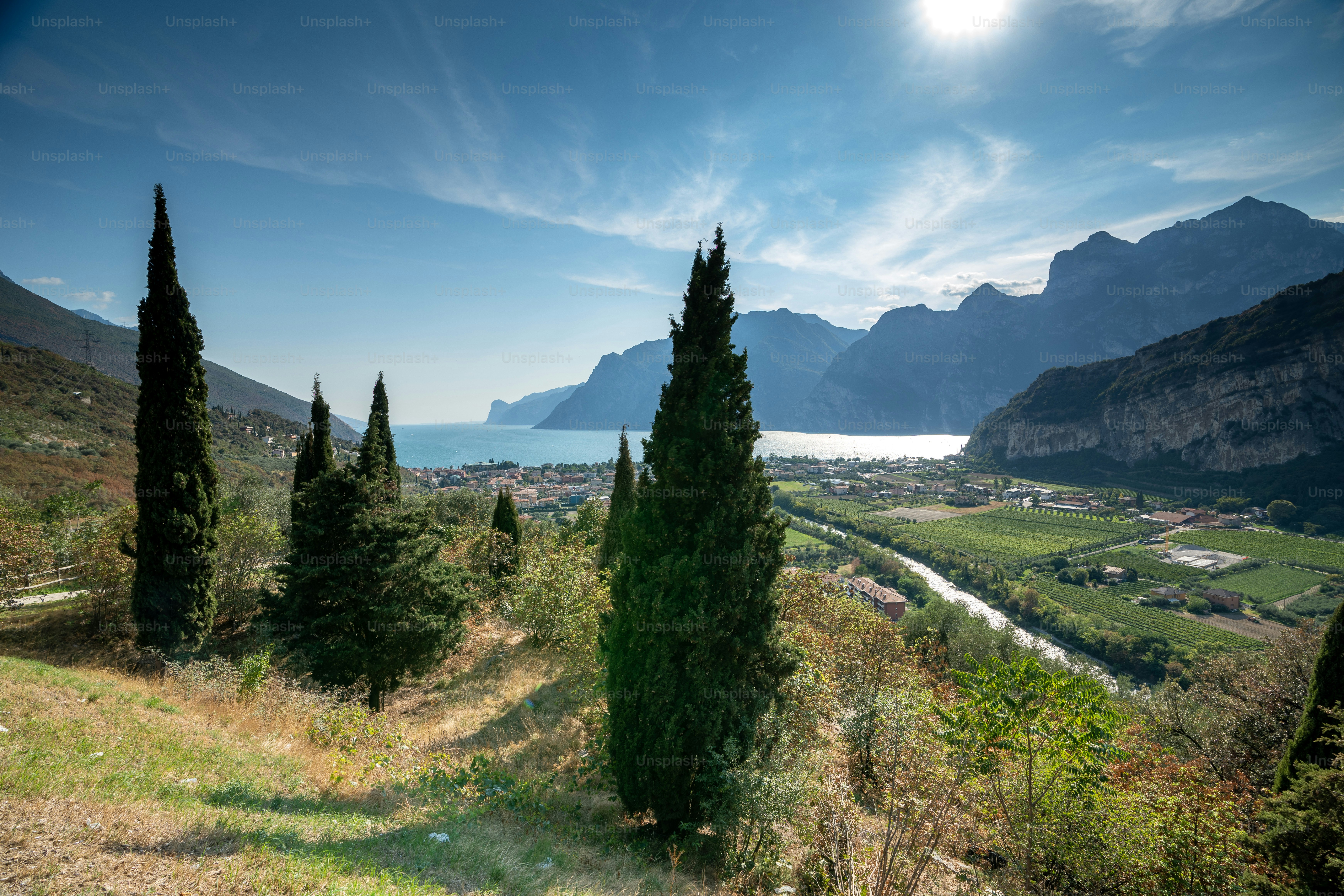 a scenic view of a valley with mountains in the background