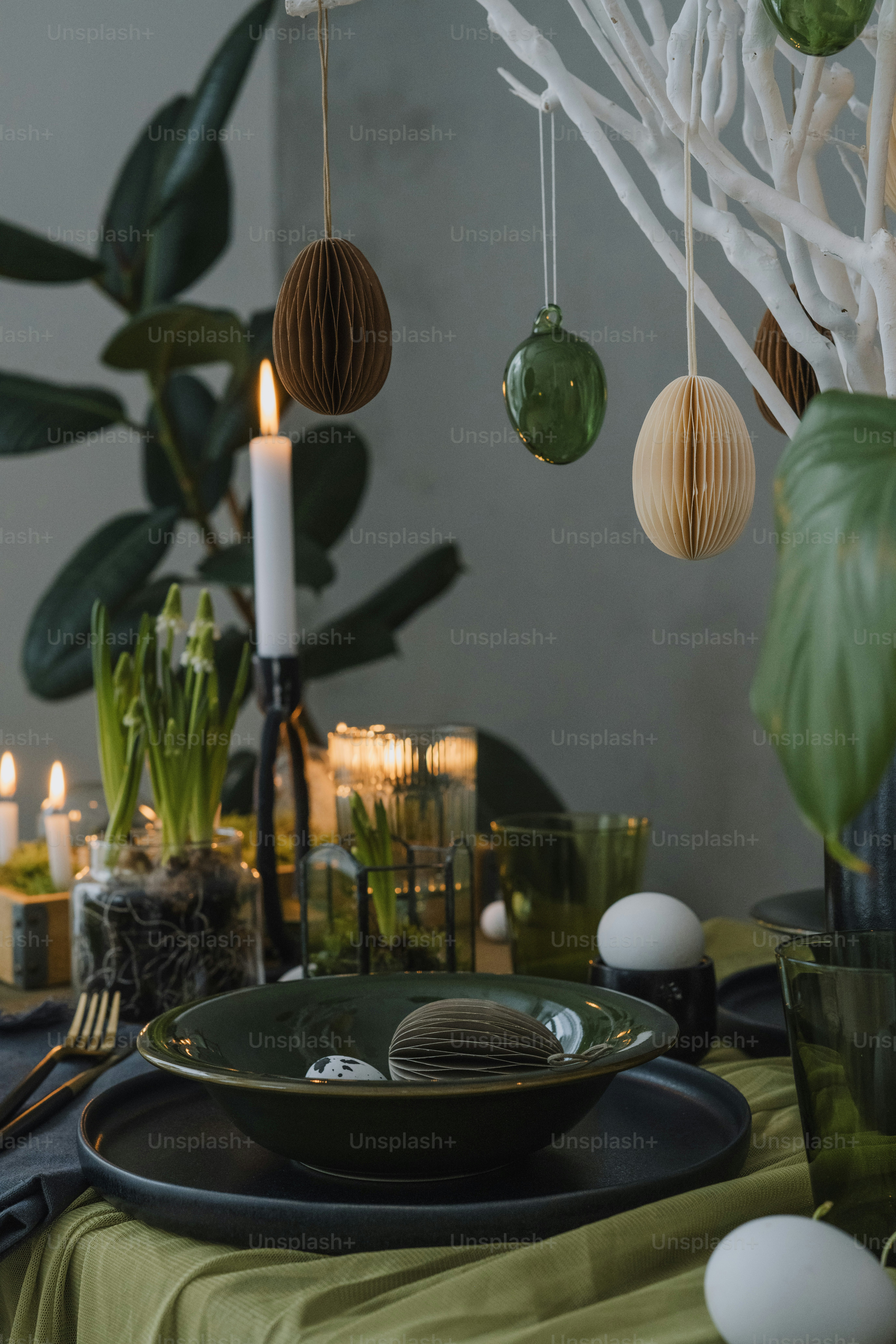 a table with a green plate and a candle