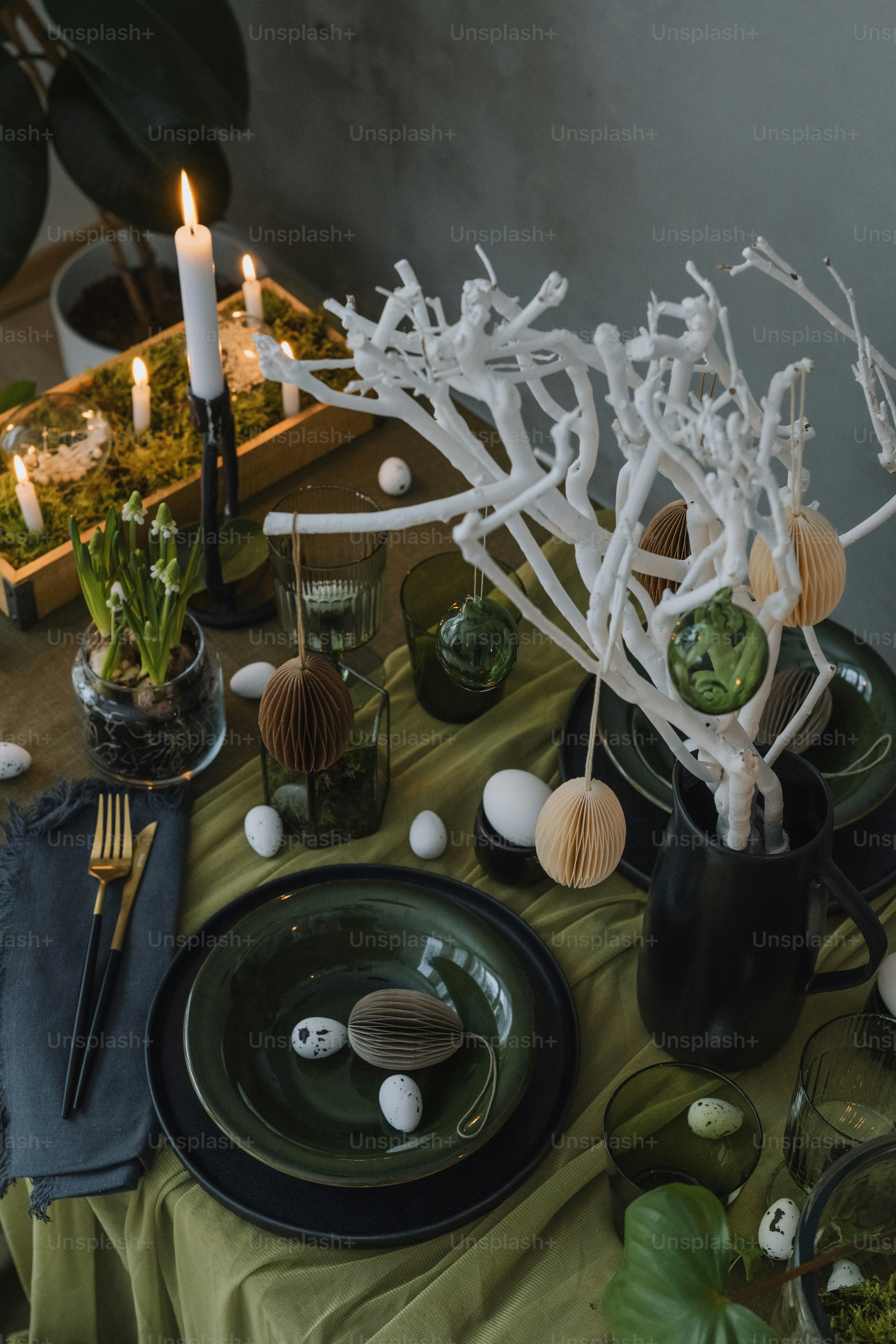 a table is set with plates and candles