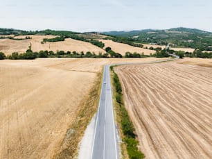 an aerial view of a road running through a field