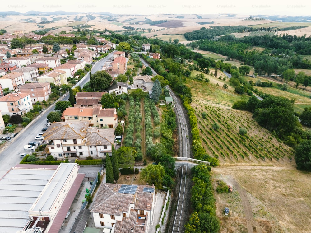 an aerial view of a town with a train track