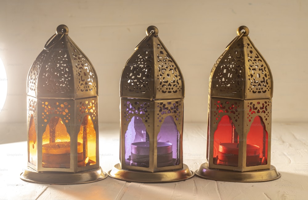 three lit candles sitting next to each other on a table