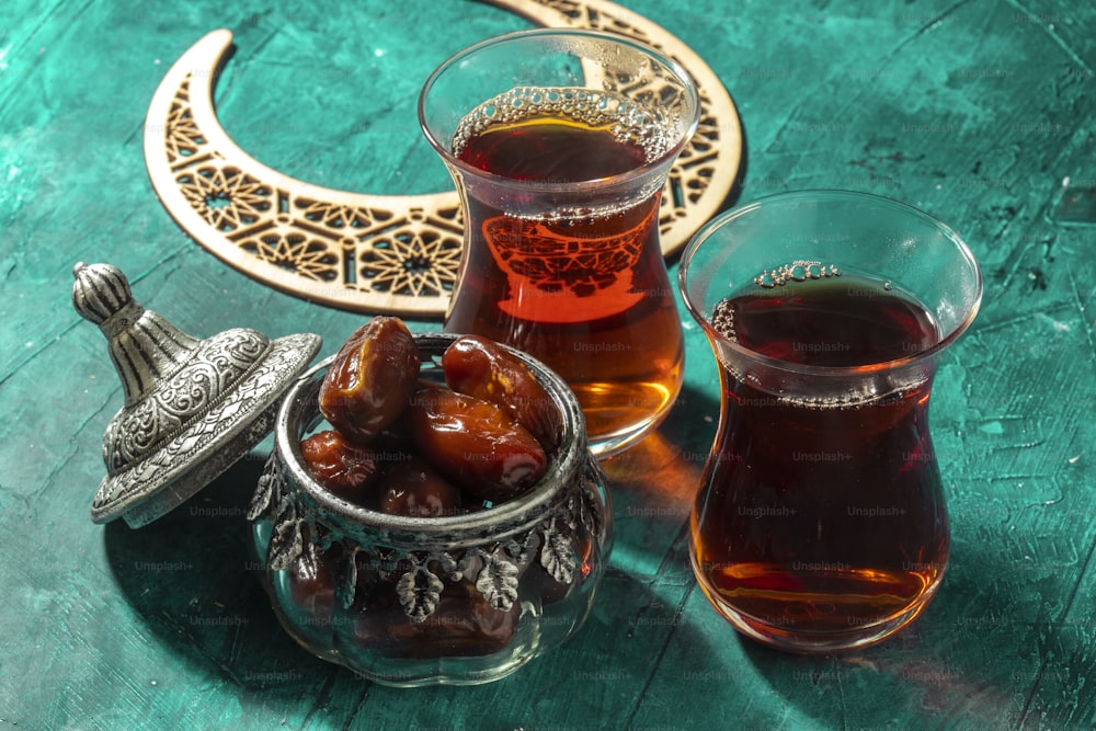 a bowl of olives and a cup of tea on a table